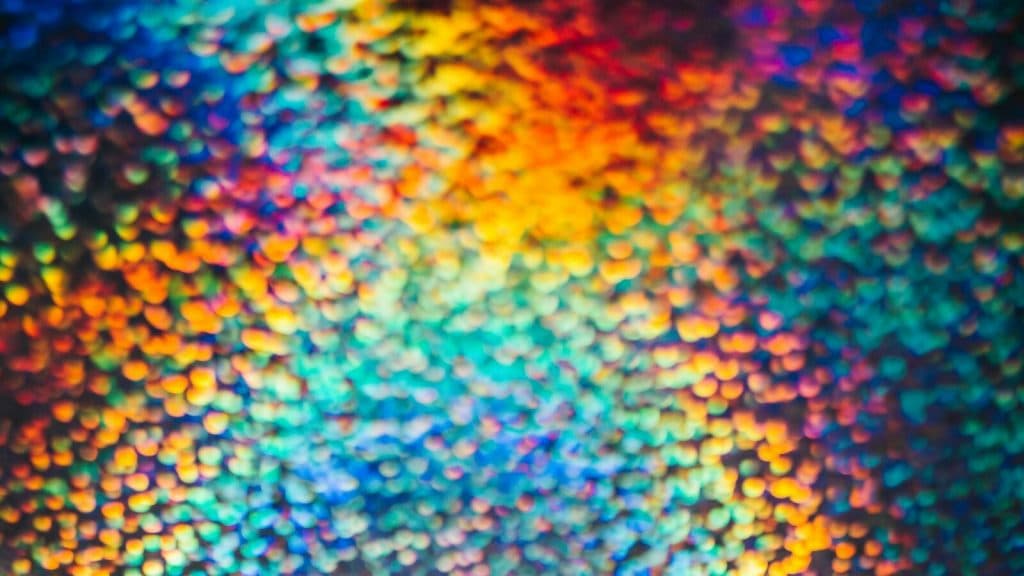 a close up of a multicolored object with a black background